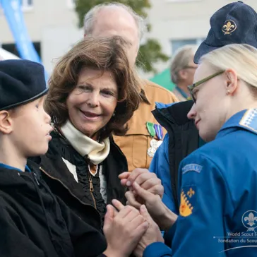 Her Majesty talking with a disabled Scout